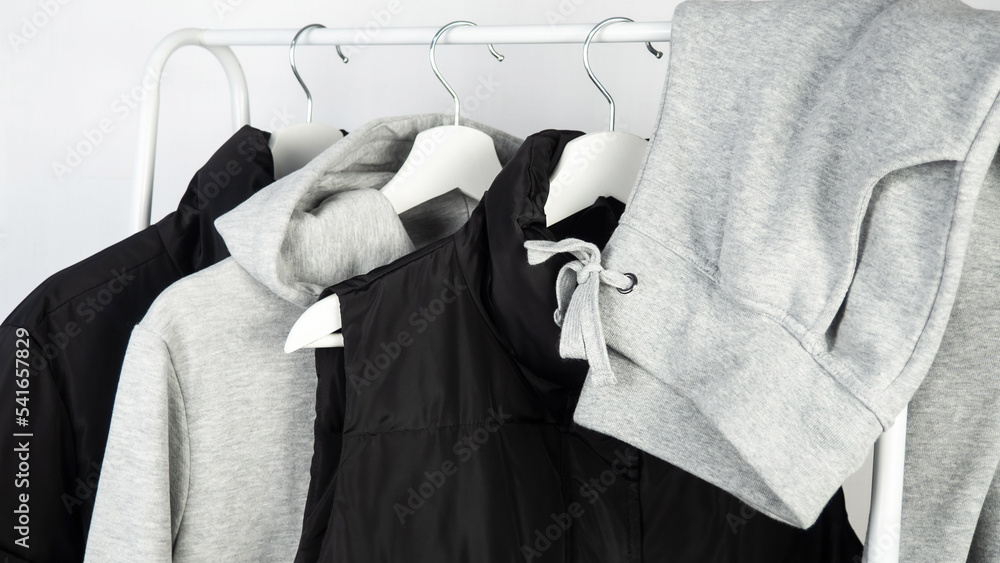 Women's, youth, sportswear hanging on a hanger. The vest is black.