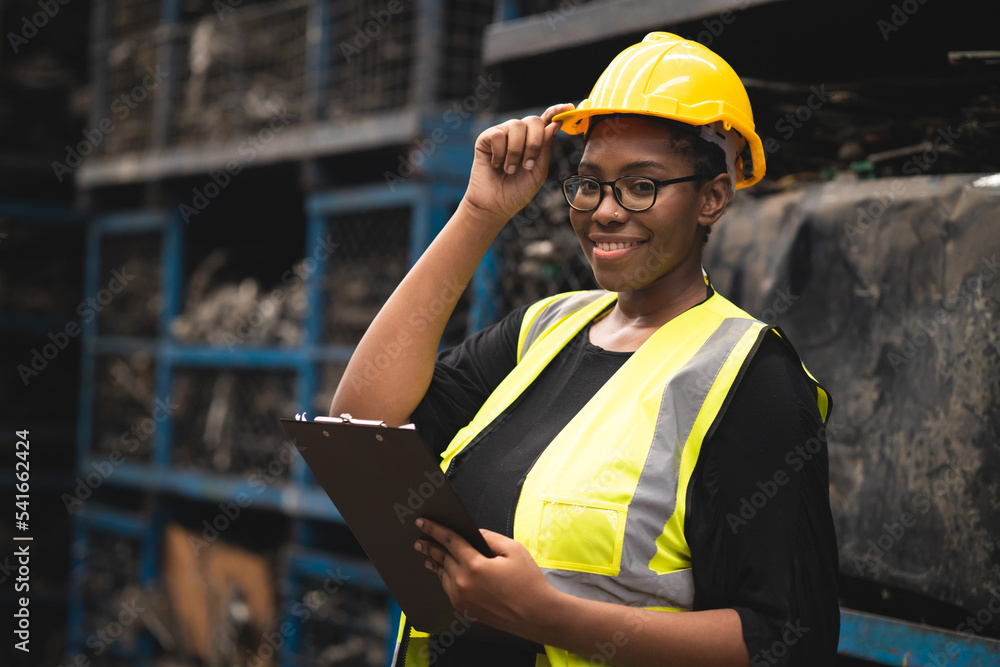 black African woman worker work in metal heavy industry machine factory as engineer team standing portrait smile black African woman worker work in metal heavy industry machine factory as engineer team standing portrait smile
