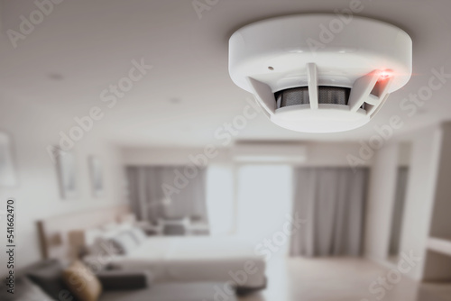 smoke detector fire alarm detector home safety device setup at home hotel room ceiling photo