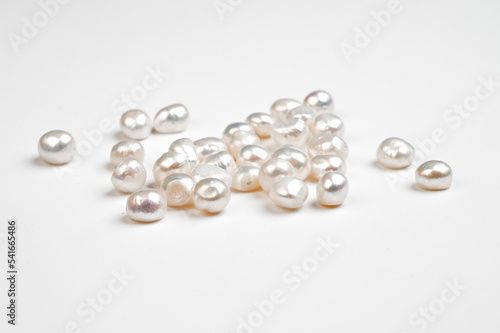 Natural freshwater round pearl beads on white background. Top view