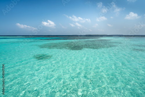 Clear turquoise water and the view of distant islands, Noonu Atoll, the Maldives 