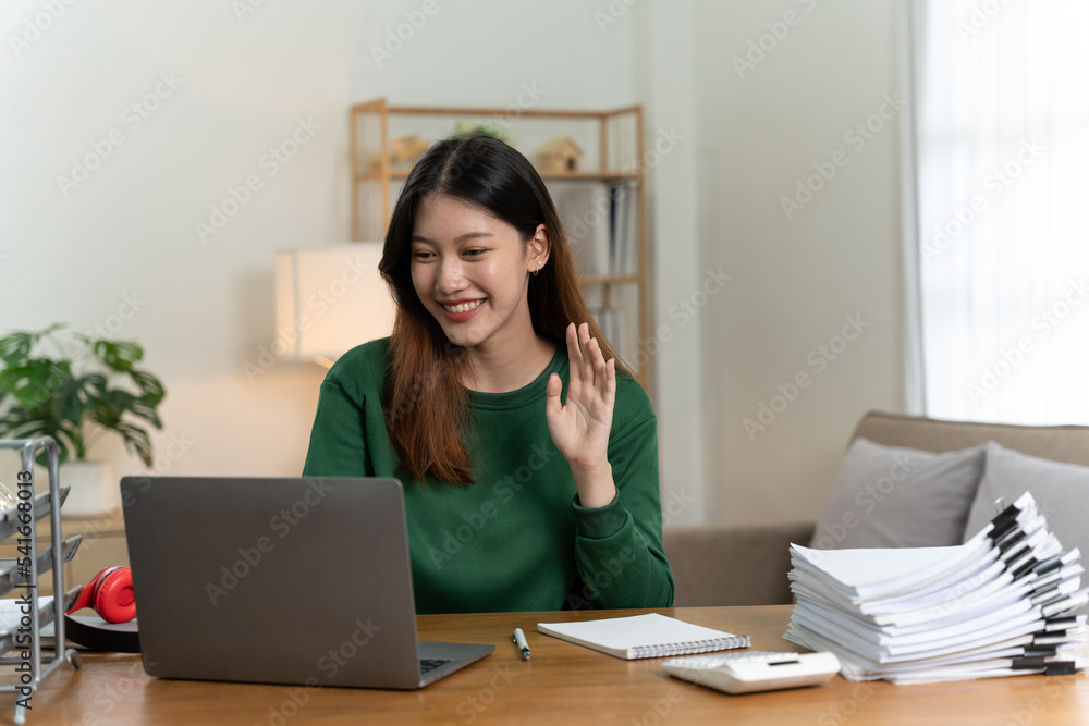 Asian girl with laptop computer on desk.