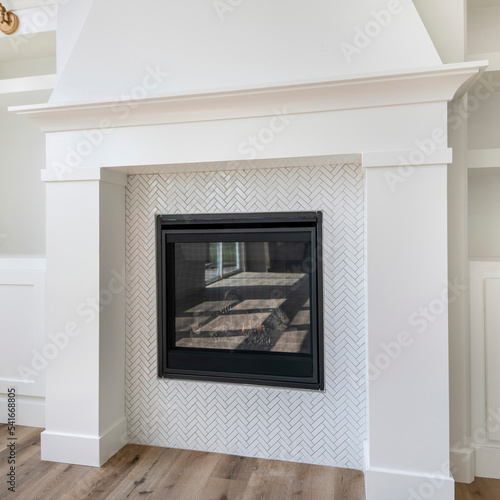 Square Fireplace with white tiles in herringbone pattern surround