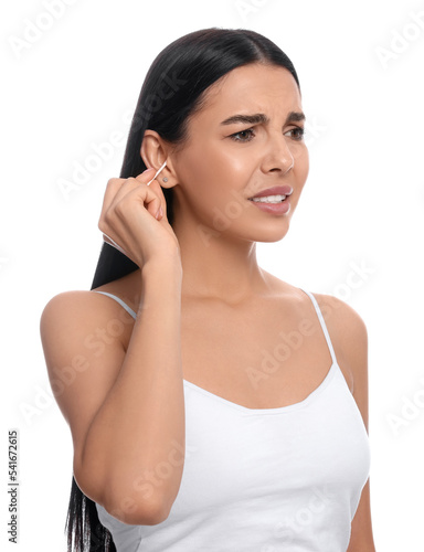 Young woman cleaning ear with cotton swab on white background