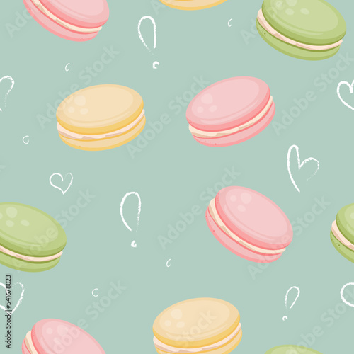 Cute cartoon colour macaroons on the turquoise background. Seamless pattern design for textile products, polygraphy, wallpapers, banners.