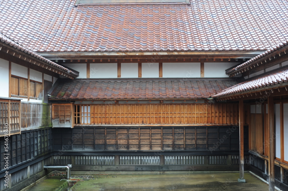 Yard or court of a traditional Japanese building with tile roof and eaves Yard or court of a traditional Japanese building with tile roof and eaves