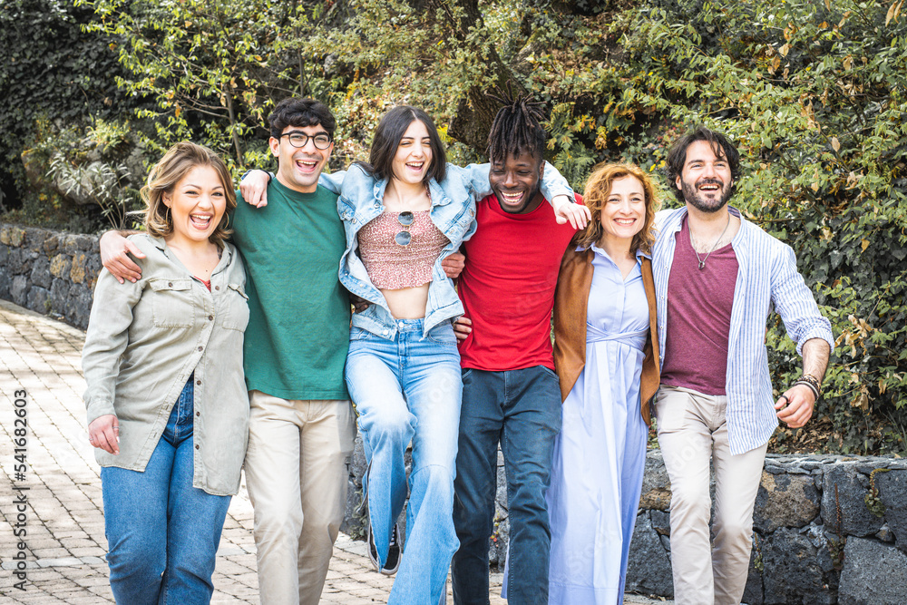 Group of friends walking, portrait of smiling people having fun together, six people joining vacation and relax time Group of friends walking, portrait of smiling people having fun together, six people joining vacation and relax time