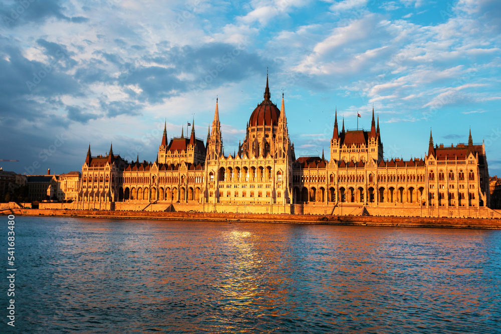 Hungarian Parliament Building along river Danube at dawn with colorful clouds sky