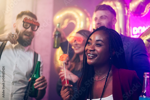 Multiracial people celebrating a party, new year's eve or birthday in the club