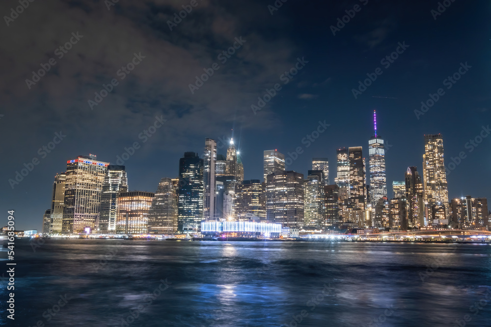 View of New York City - beautiful landscape, from Brooklyn Bridge Park, waterfront at night over bridge View of New York City - beautiful landscape, from Brooklyn Bridge Park, waterfront at night over bridge