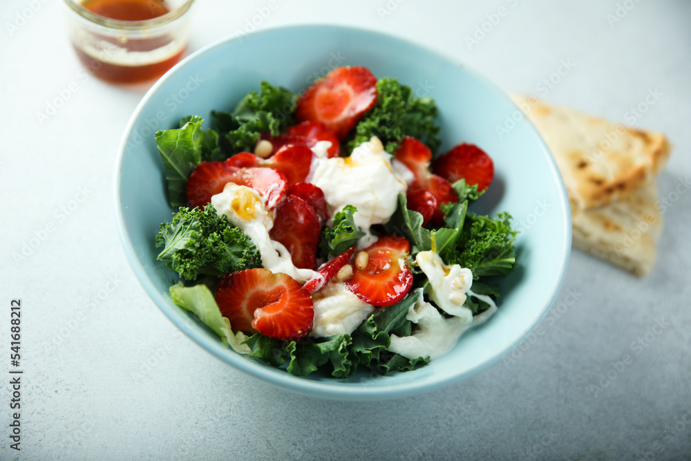 Kale salad with fresh cheese and strawberry