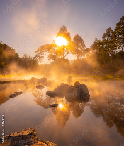 Natural hot spring with steam, rock and reflection in the morning at Chae Son National Park, Lampang, Thailand.