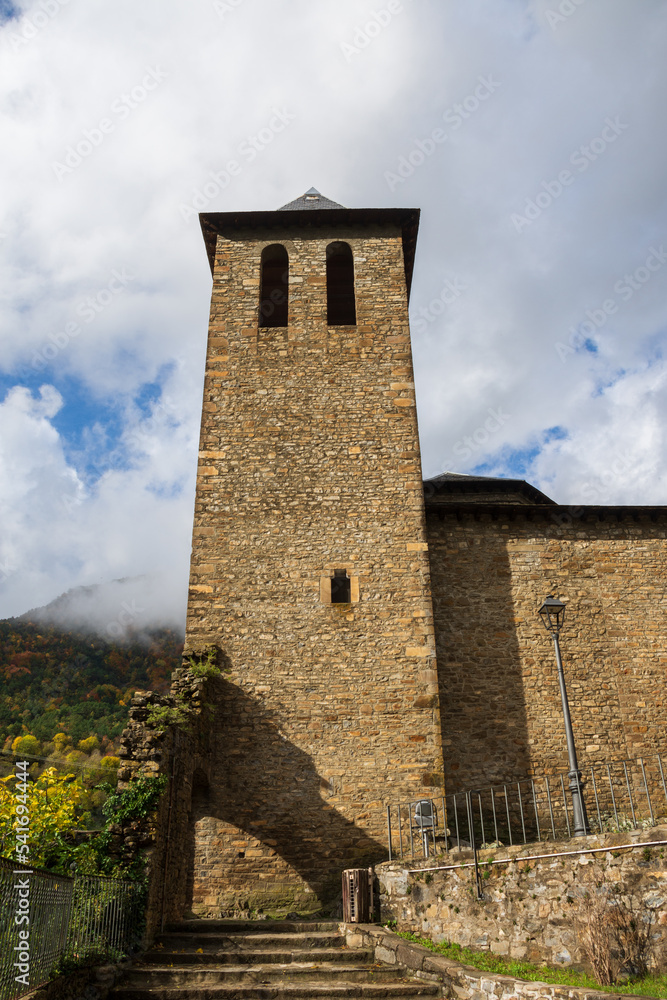 Autumnal view of the tower of the Romanesque church of Torla, in Huesca, Spain, vertical