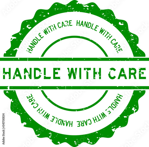 Grunge green handle with care word round rubber seal stamp on white background