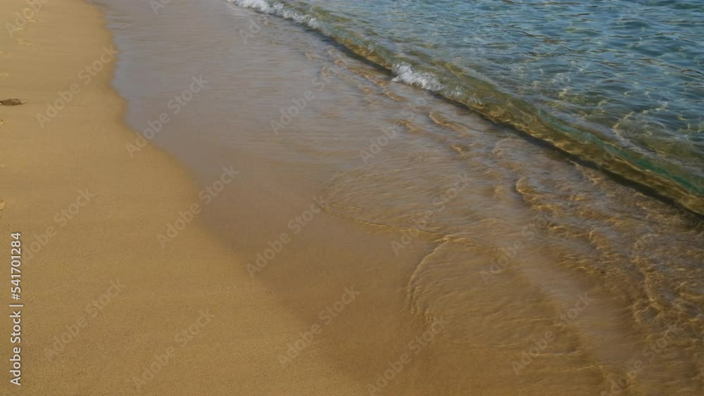 Close up of the turquoise sandy beach with clear waters of Mylopotas in Ios Greece Close up of the turquoise sandy beach with clear waters of Mylopotas in Ios Greece