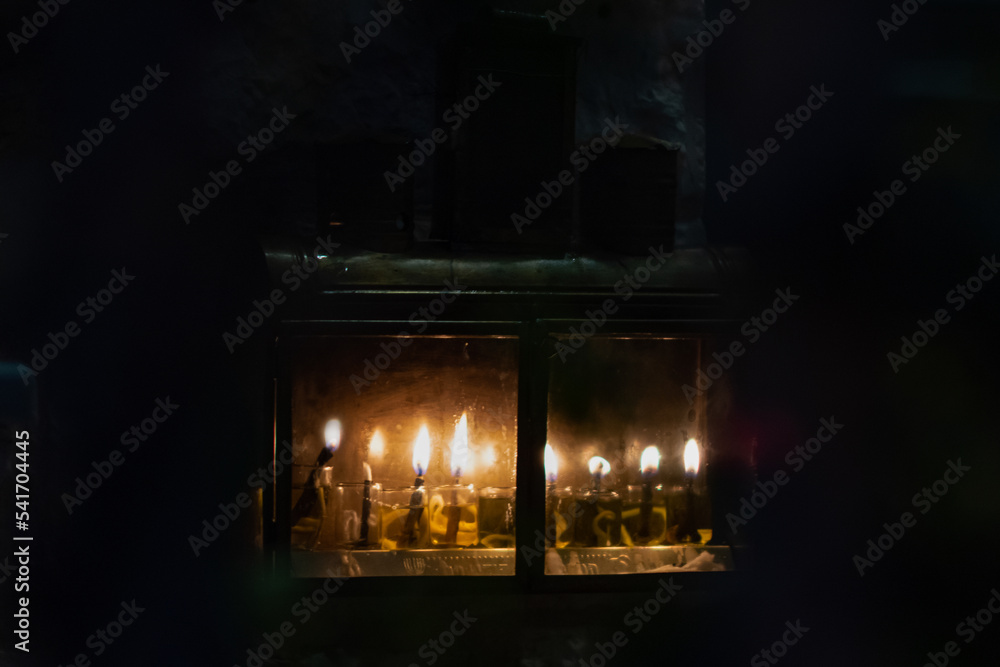 Hanukkah candles burning in protective glass housing in Jerusalem, where it is traditional to burn oil instead of wax in small vials during the celebration of the Festival of Lights in Israel.