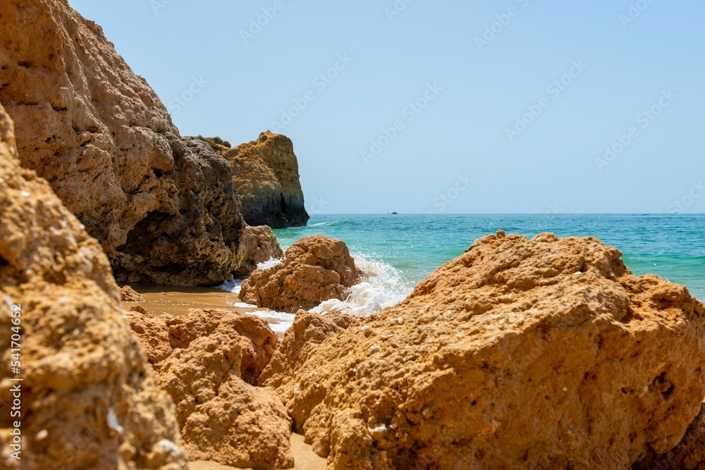 Fototapeta premium Orange rock formations on the sandy beach in Portugal
