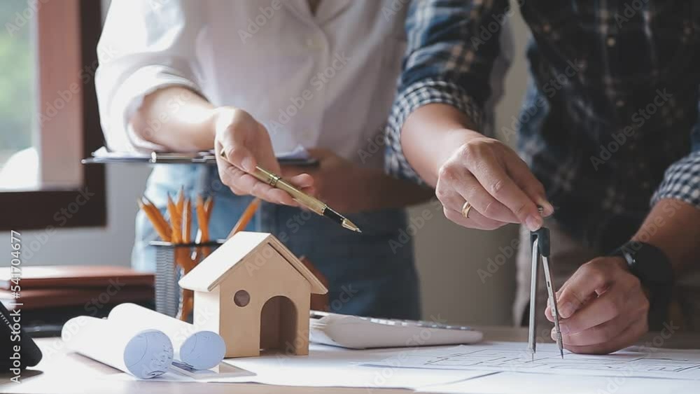 Construction engineer working at blueprint to build large commercial buildings in office. Engineering tools and construction concept. Construction engineer working at blueprint to build large commercial buildings in office. Engineering tools and construction concept.