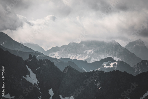 snow covered mountains and clouds