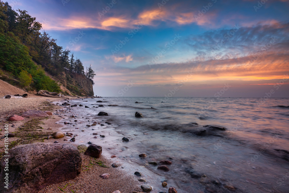 Baltic Sea beach in Gdynia Orlowo with the cliff at sunrise, Poland