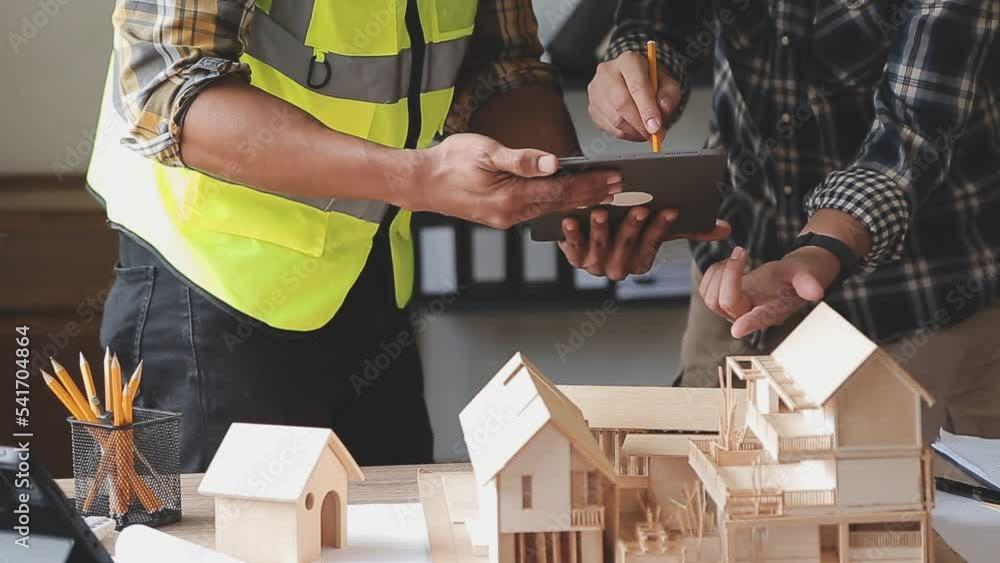 Construction engineer working at blueprint to build large commercial buildings in office. Engineering tools and construction concept.