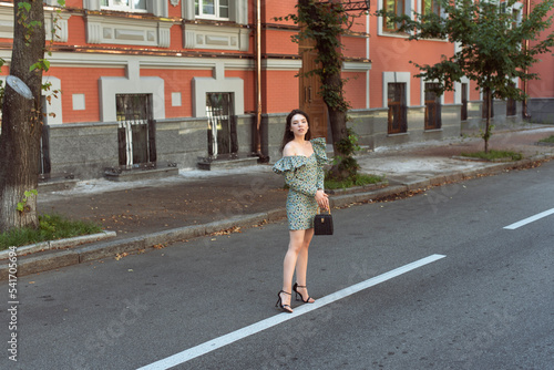 Young woman walking in summer city