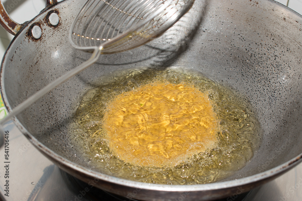 Step by step process of Deep frying Poori or Luchi in oil . Indian fried bread made from wheat