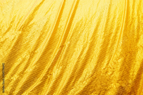 Yellow bed linen gradient texture blurred curve style of abstract luxury fabric,Wrinkled bed linen and gold shadows,background