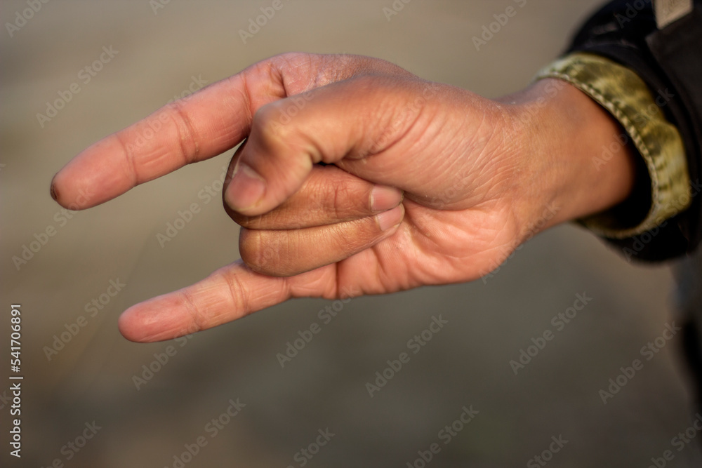 Showing two fingers like devil horns and the background blur Showing two fingers like devil horns and the background blur
