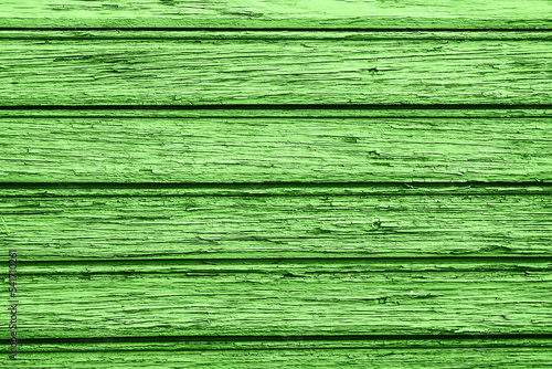 Wooden desk background. Peeling paint pattern. Old peeling paint texture. Grunge cracked wall background. Green color weathered surface. Broken wood structure. Vintage pattern design.