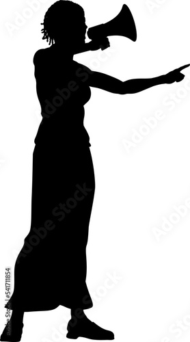 Protestor or demonstrator at a demonstration march, picket line or strike protest rally in silhouette. Using a megaphone, mega phone or bullhorn.