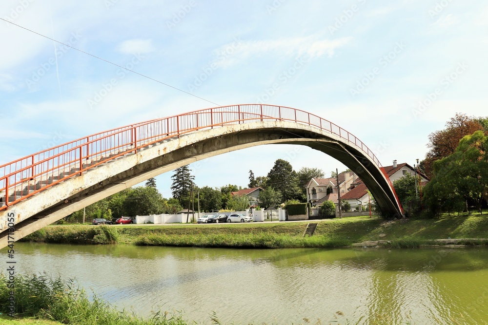 Concrete bridge for pedestrians and cyclists across the river