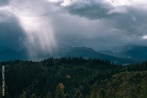 Dramatic landscape  sunbeams breaking through the clouds