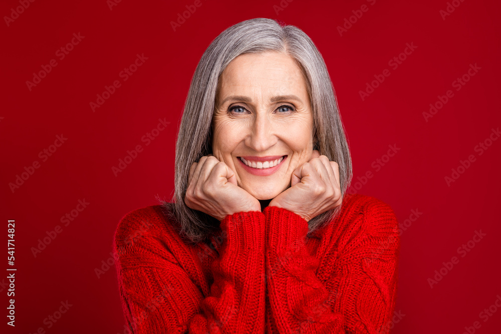 Photo of adorable cute cheerful grandmother hands cheeks shiny smile wear knitted pullover isolated red color background Photo of adorable cute cheerful grandmother hands cheeks shiny smile wear knitted pullover isolated red color background