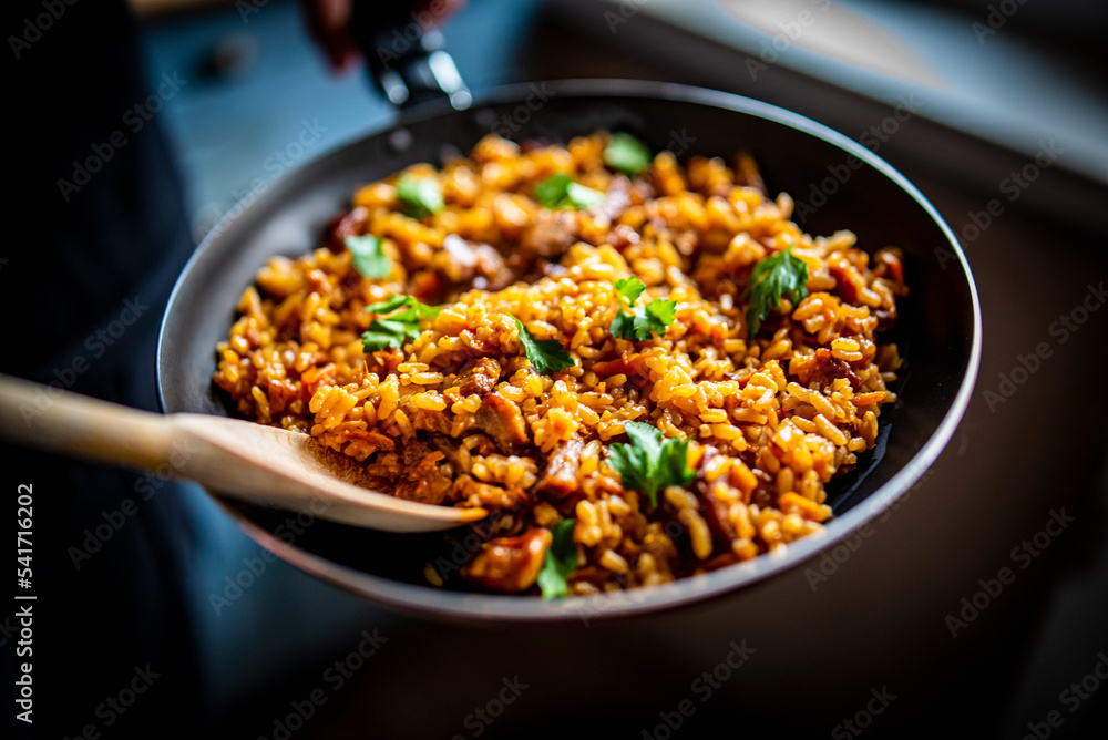 cooking rice, meat and vegetable in pan on kitchen cooking rice, meat and vegetable in pan on kitchen