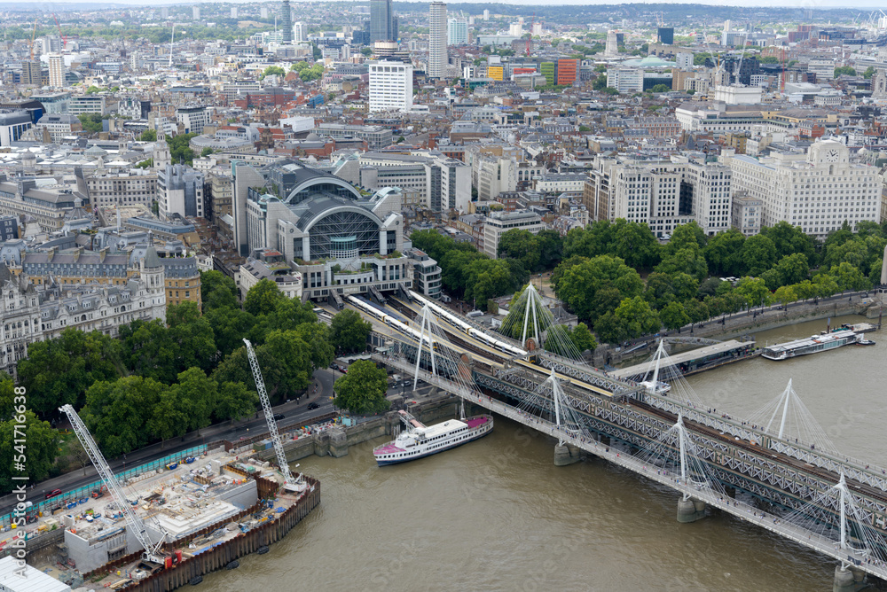 Aerial view of Hungerford Railway Bridge and Golden Jubilee Bridges at City of Westminster on a cloudy summer day. Photo taken August 3rd, 2022, London, United Kingdom.