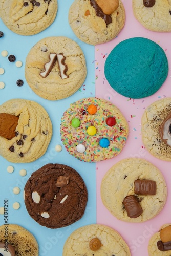 Cookies in different colors decorated with chocolate bars, and crumbs