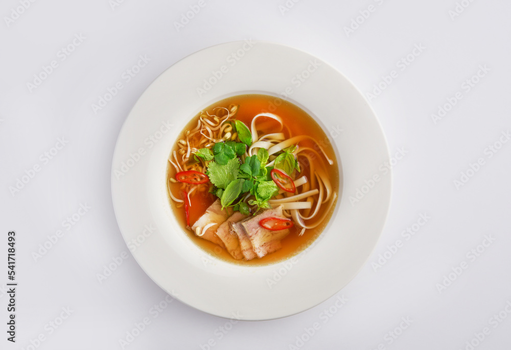 Pho Bo vietnamese soup with beef and rice noodles on a white background, top view. Asian fast food culture concept, Chinese or Thai cuisine Pho Bo vietnamese soup with beef and rice noodles on a white background, top view. Asian fast food culture concept, Chinese or Thai cuisine
