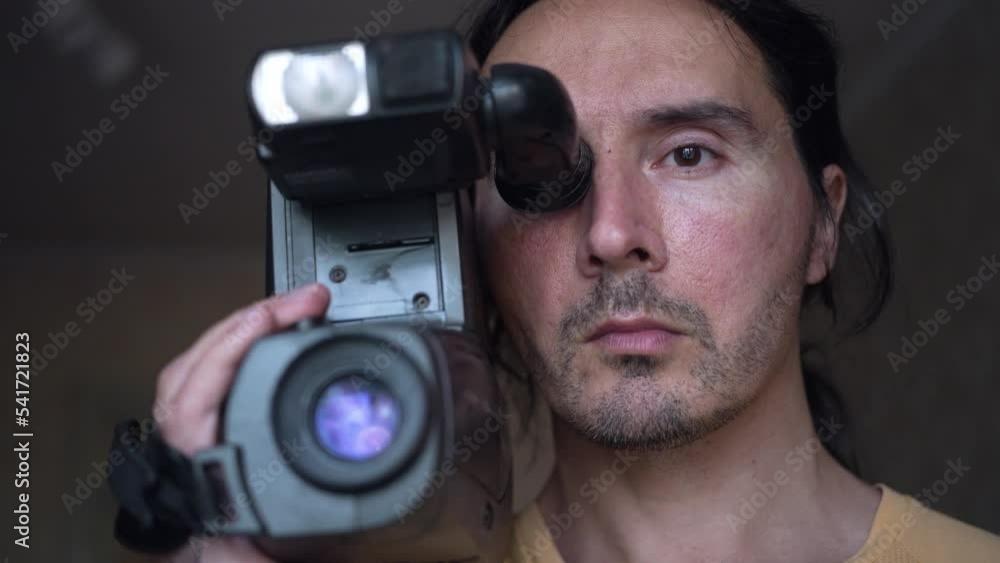 A handsome cameraman with a retro camcorder, man with camera. Slow motion A handsome cameraman with a retro camcorder, man with camera. Slow motion