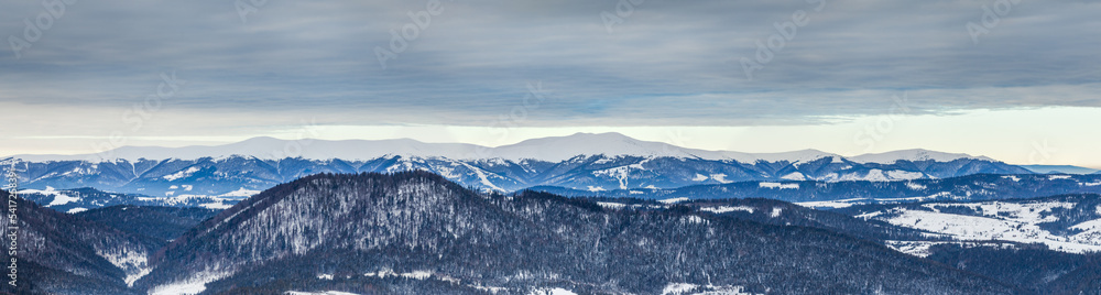 Mountain peak with snow blow by wind. Winter landscape. Cold day, with snow.