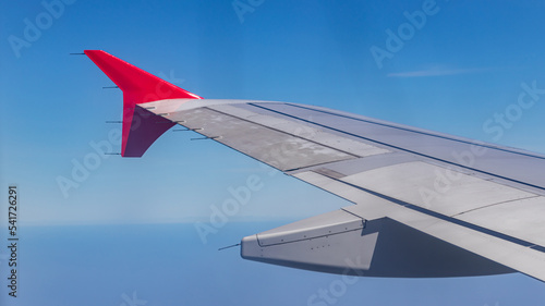 Wing of an airplane flying above clouds. Wing of an airplane. view from the window of an airplane flying.