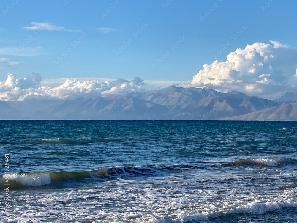 stormy sea in Acharavi, small resrt in Corfu island, Greece with Albania mountains in a distance