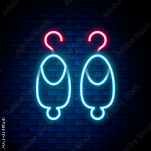 Glowing neon line Earrings icon isolated on brick wall background. Jewelry accessories. Colorful outline concept. Vector