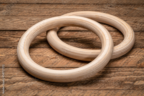 pair of gymnastic rings made of layered birch wood, fitness and calisthenics concept