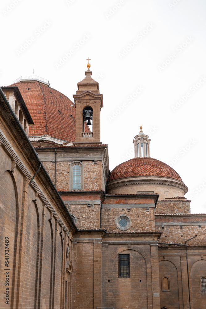 Vintage brick church with a dome and a bell in the historic Italian city of Florence