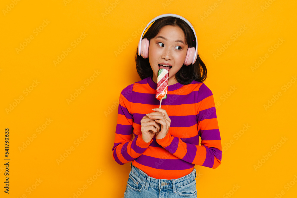 Asian brunette woman smiling and holding grapefruit Asian brunette woman smiling and holding grapefruit