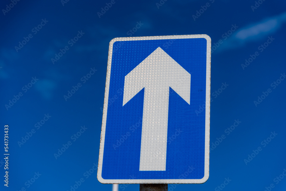 One way sign set against a blue sky
One way sign set against a blue sky