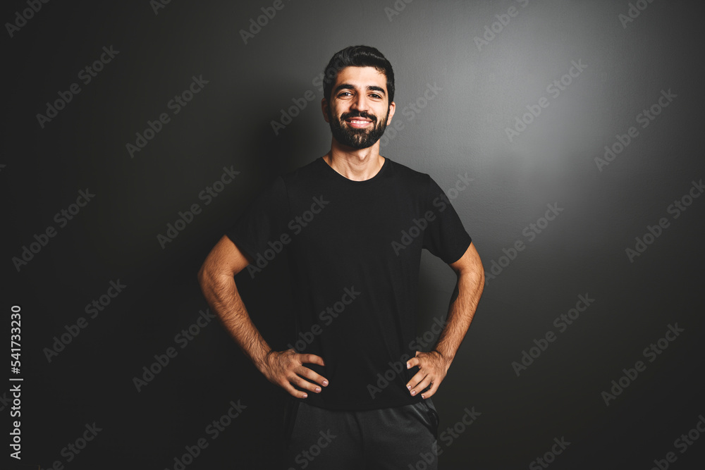 Portrait of a man trainer fitness gym black background training in fitness gym.