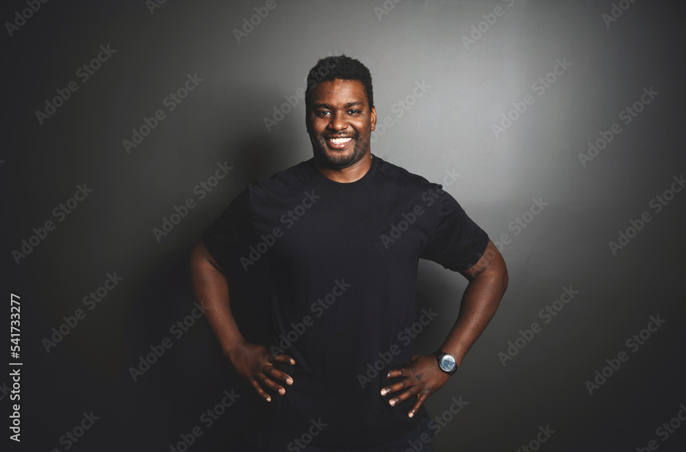 Portrait of a man trainer at fitness gym black background. Workout training in fitness gym. Portrait of a man trainer at fitness gym black background. Workout training in fitness gym.