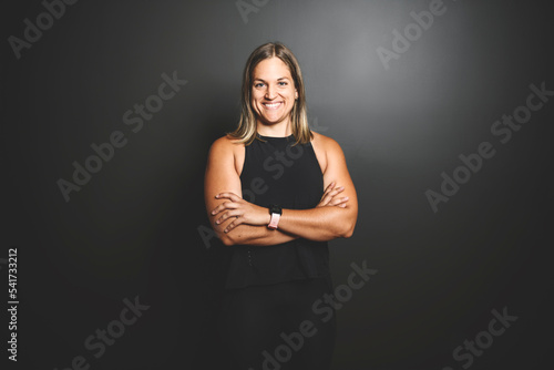 Happy sports woman celebrating his success over black background